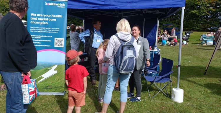 Healthwatch stand surrounded by people at Amesbury Super Fete