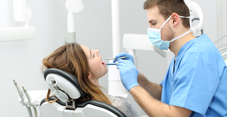 male dentist and female patient in chair