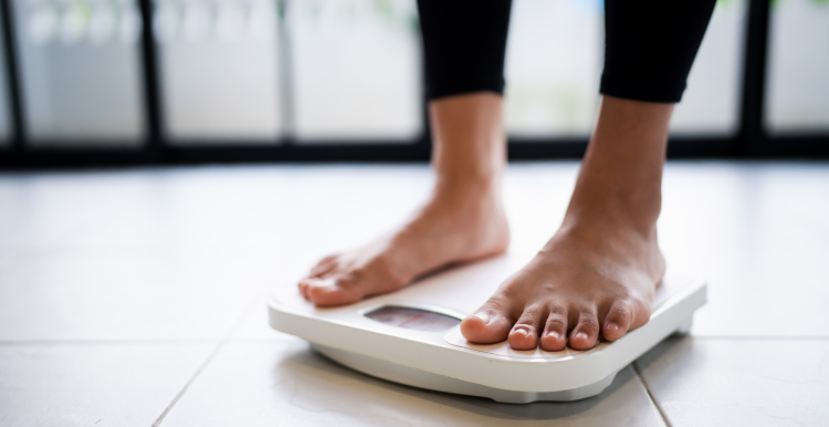 Bare feet on a weighing scale.