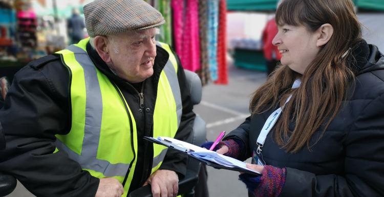 Healthwatch talking to man at market