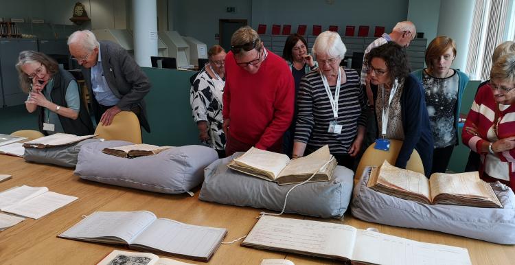 volunteers looking at archives