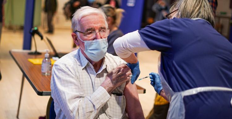 man receiving covid vaccine