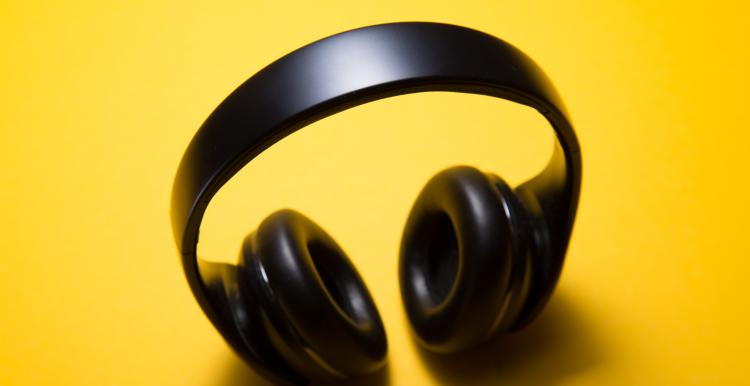 black headphones on a yellow background