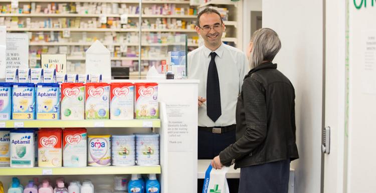 woman talking to male pharmacist