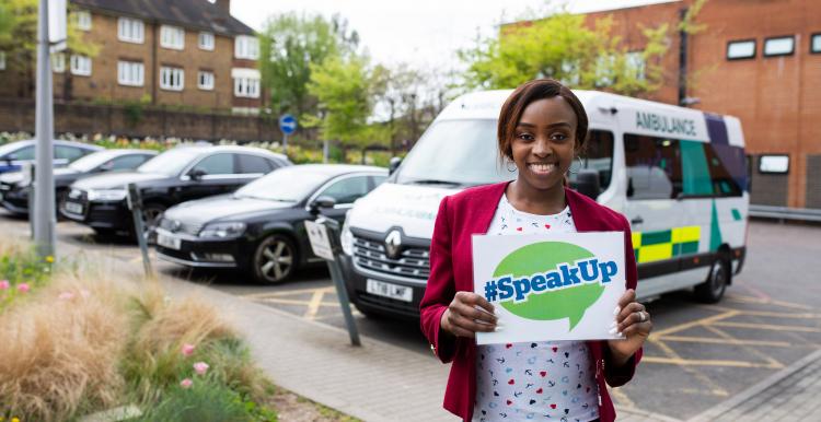 woman holding speak up banner