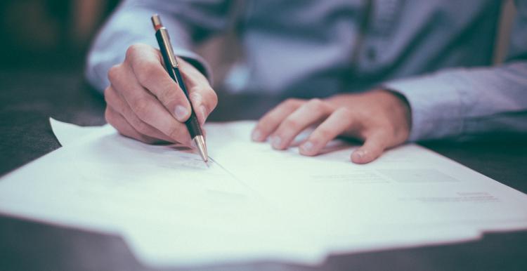 person filling in paperwork