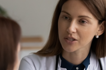 female doctor wearing stethoscope talking to patient