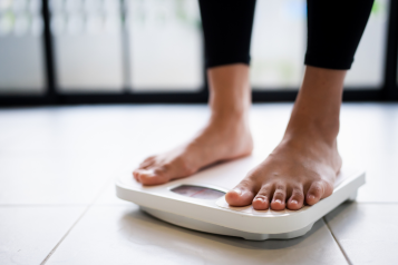 Bare feet on a weighing scale.