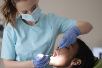 A dentist examining a patient.