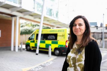 woman standing in front of ambulance