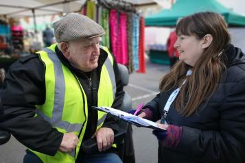 Healthwatch talking to man at market