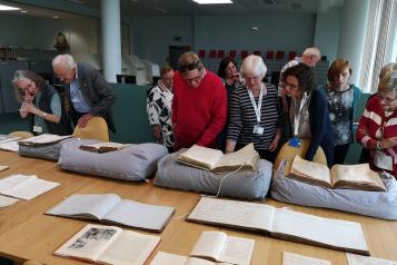 volunteers looking at archives