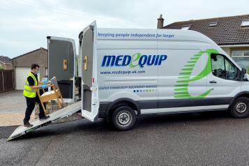 man loading chair onto Medequip van