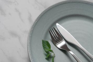 knife and fork on empty white plate